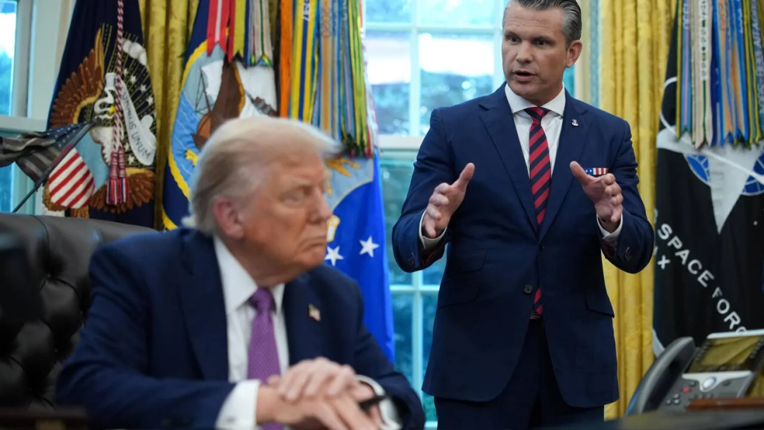 US President Donald Trump and Defense Secretary Pete Hegseth (R) address a rare gathering of hundreds of top military officers on Tuesday. Kevin Dietsch / GETTY IMAGES NORTH AMERICA/AFP/File
