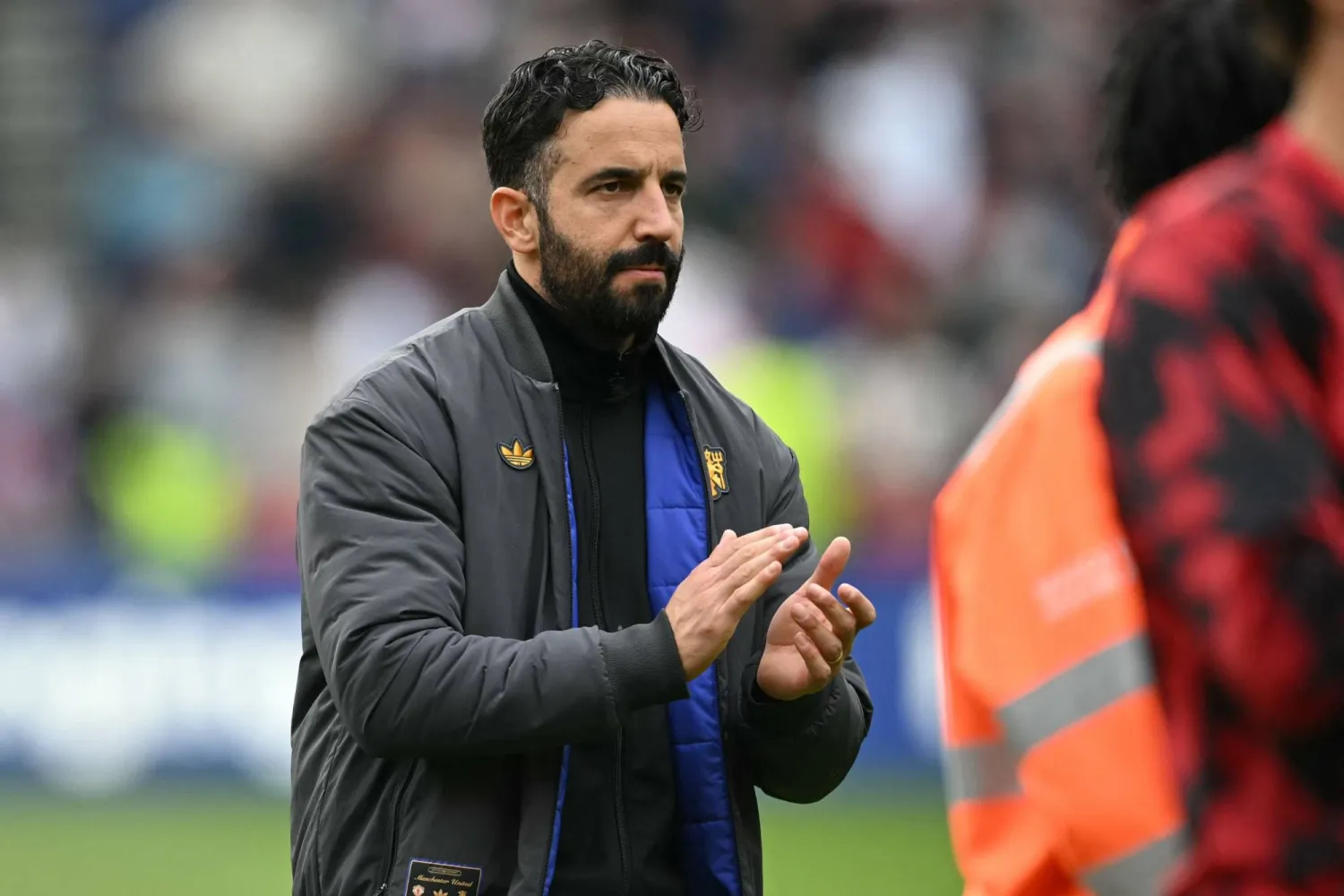 Manchester United's Portuguese head coach Ruben Amorim applauds fans on the pitch after the English Premier League football match between Brentford and Manchester United at the Gtech Community Stadium in London on September 27, 2025. (AFP)