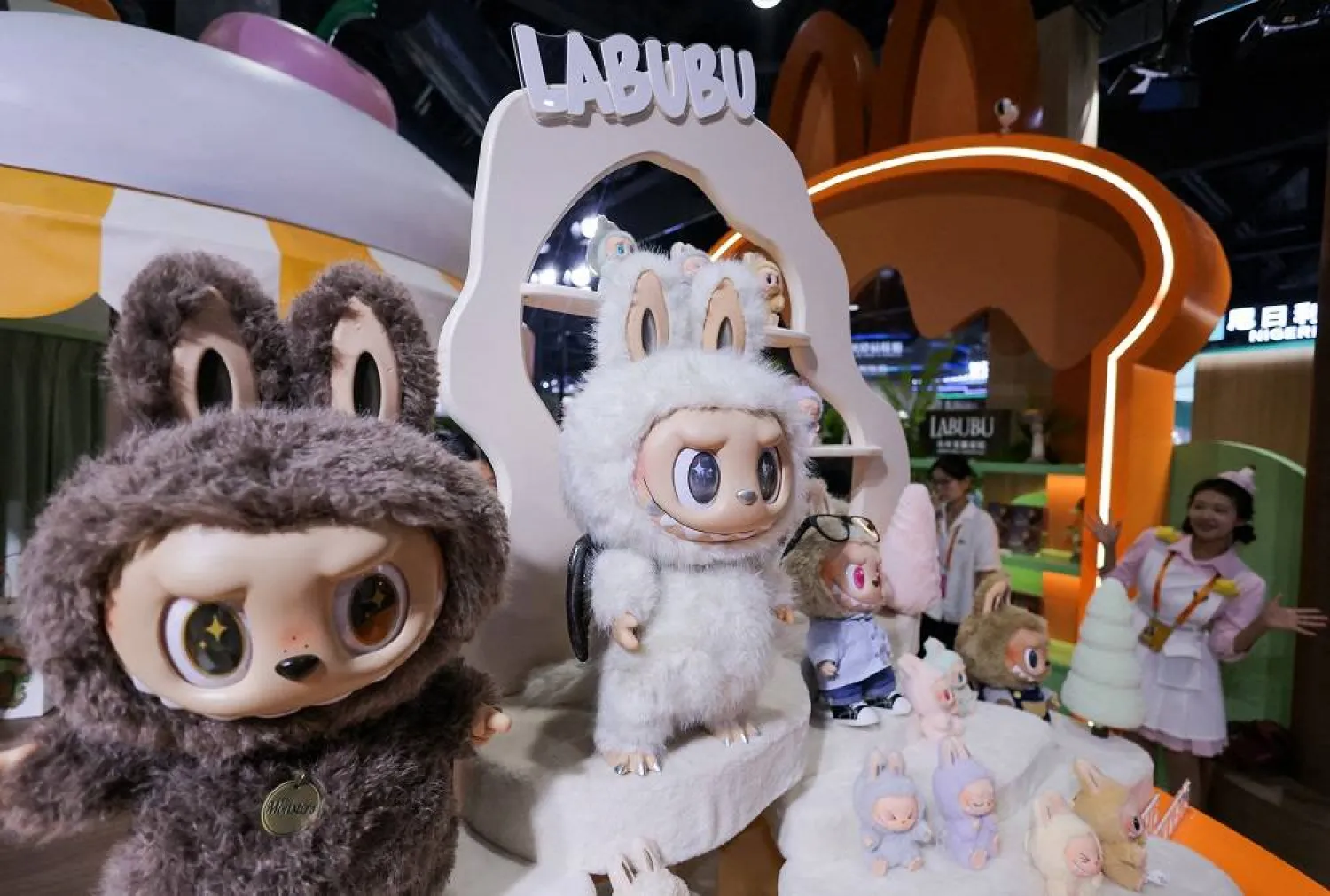 An employee gestures next to Labubu toys on display at Pop Mart's booth at China International Fair for Trade in Services (CIFTIS) in Beijing, China, September 10, 2025. (Reuters)