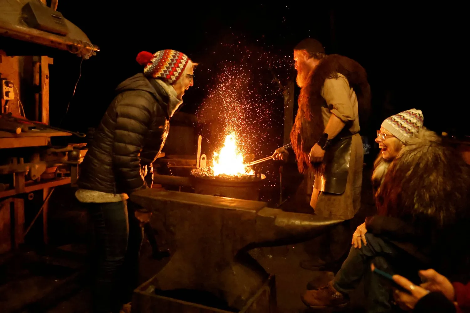 Ironmonger Tom King heats metal for tourist Terri Winter, 68, to hammer in his forge, as her friend Darlene Molitor, 67, from Minnesota in the US, looks on, as part of his immersive ancient Celtic experience, in Bohermeen, Ireland, September 23, 2025. (Reuters)