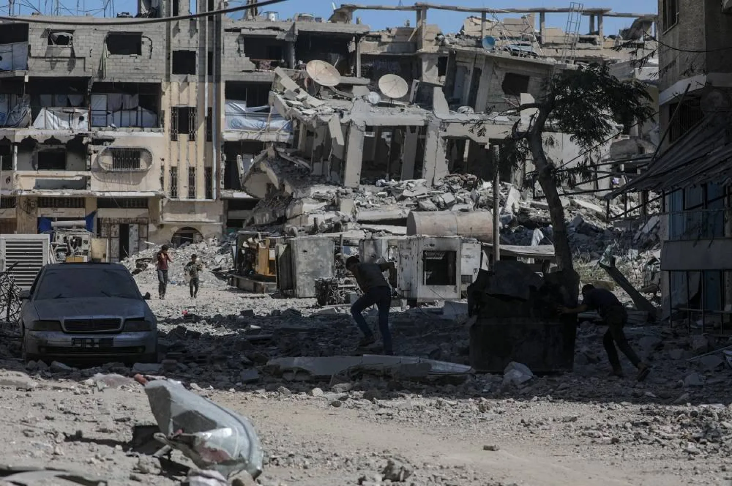 Palestinians walk through a destroyed area following Israeli airstrikes in Gaza City, Gaza Strip, 30 September 2025. (EPA)