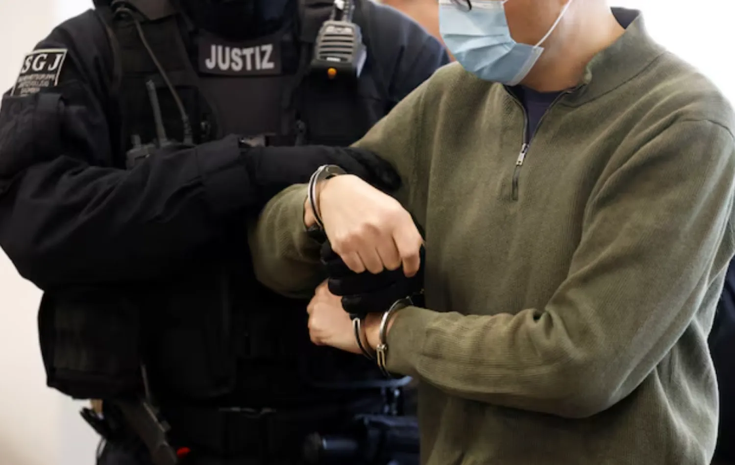Defendant Jian G., a former assistant to then-member of the European Parliament Maximilian Krah, of the far-right Alternative for Germany (AFD) party, is getting uncuffed as he arrives at the courtroom for a high-profile espionage trial, in Dresden, Germany, on September 30, 2025. ODD ANDERSEN/Pool via REUTERS