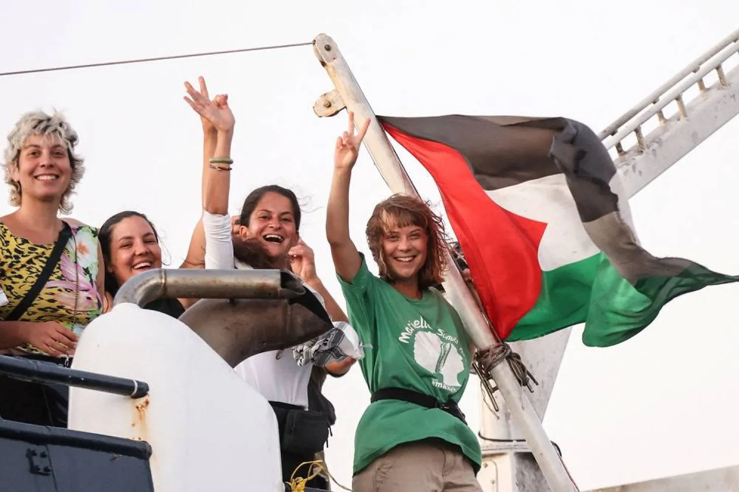  Greta Thunberg and a crew member flash victory signs from their ship, part of the Global Sumud Flotilla aiming to reach Gaza and break Israel's naval blockade, as they sail off Crete island, Greece, September 25, 2025. (Reuters)