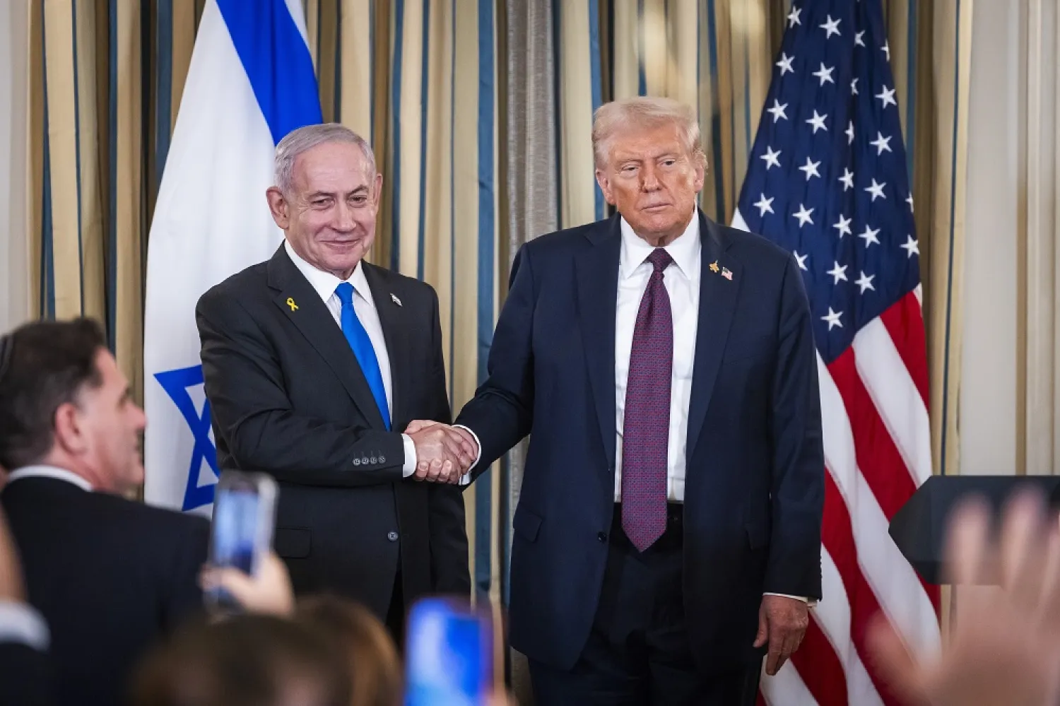 US President Donald Trump (R) shakes hands with Israeli Prime Minister Benjamin Netanyahu (L) after they spoke at a press conference in the State Dining Room of the White House in Washington, DC, USA, 29 September 2025. (EPA)