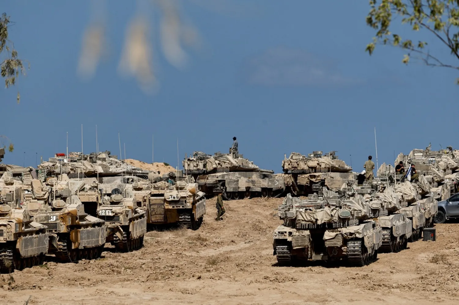 Israeli soldiers, tanks and armored personnel carriers (APCs) near the Israel-Gaza border, in Israel, September 16, 2025. (Reuters) 
