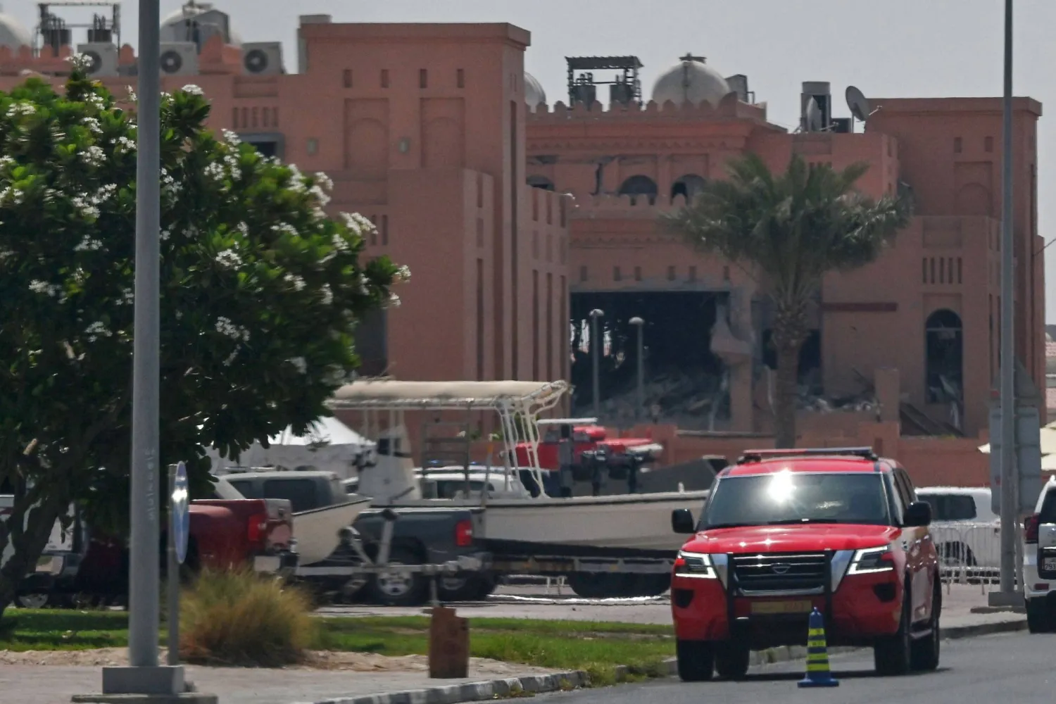 A picture taken from a distance shows in the background the damaged building housing members of Hamas's political bureau which was targeted the previous day by an Israeli strike in Qatar's capital Doha, on September 10, 2025. (Photo by AFP)