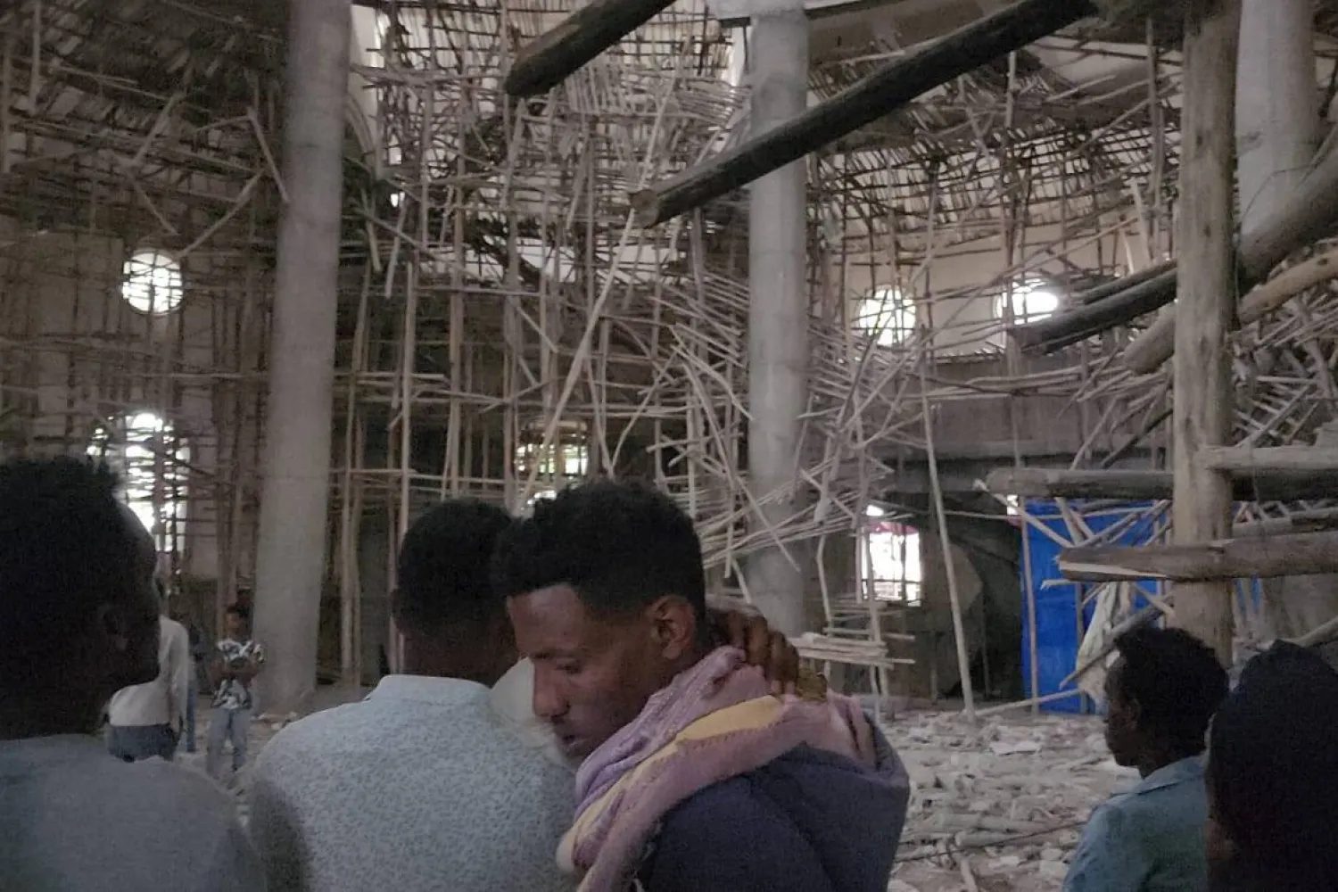 Worshippers stand inside the Menjar Shenkora Arerti Mariam Church under construction that collapsed in Arerti, Amhara region of northern Ethiopia, on Wednesday, Oct. 1, 2025. (AP Photo/Samuel Getachew)