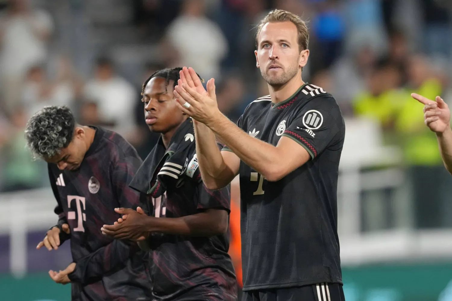 Bayern's Harry Kane, right, with teammates applaud their fans after the Champions League opening phase soccer match between Pafos FC and FC Bayern Munich at Alphamega stadium in Limassol, Cyprus, Tuesday, Sept. 30, 2025. (AP Photo/Petros Karadjias)