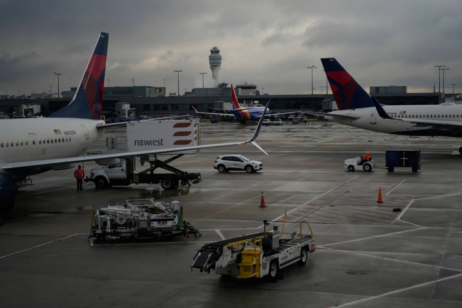 FILE - Delta Airlines planes are loaded along the B Concourse at the Hartsfield-Jackson International Airport, Nov. 26, 2024, in Atlanta. (AP Photo/Carolyn Kaster, File)