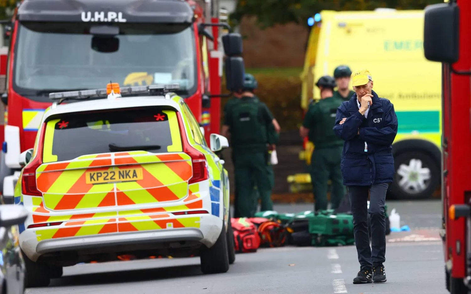 Security people and members of the emergency services work inside a Police cordon near Heaton Park Hebrew Congregation synagogue in Crumpsall, north Manchester, on October 2, 2025. (Photo by Paul Currie / AFP)
