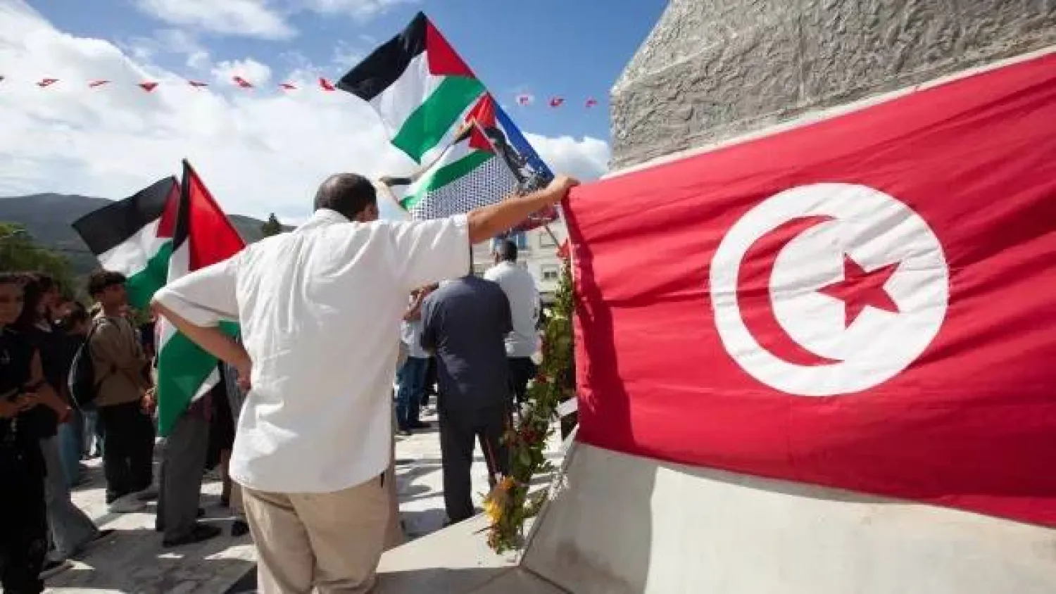 Demonstrators gather at a memorial site honoring the victims of the 1985 Israeli attack on Palestine Liberation Organization’s headquarters, in Hammam Chott outside Tunisia’s capital, Wednesday, Oct. 1, 2025. (AP Photo/Ons Abid) 