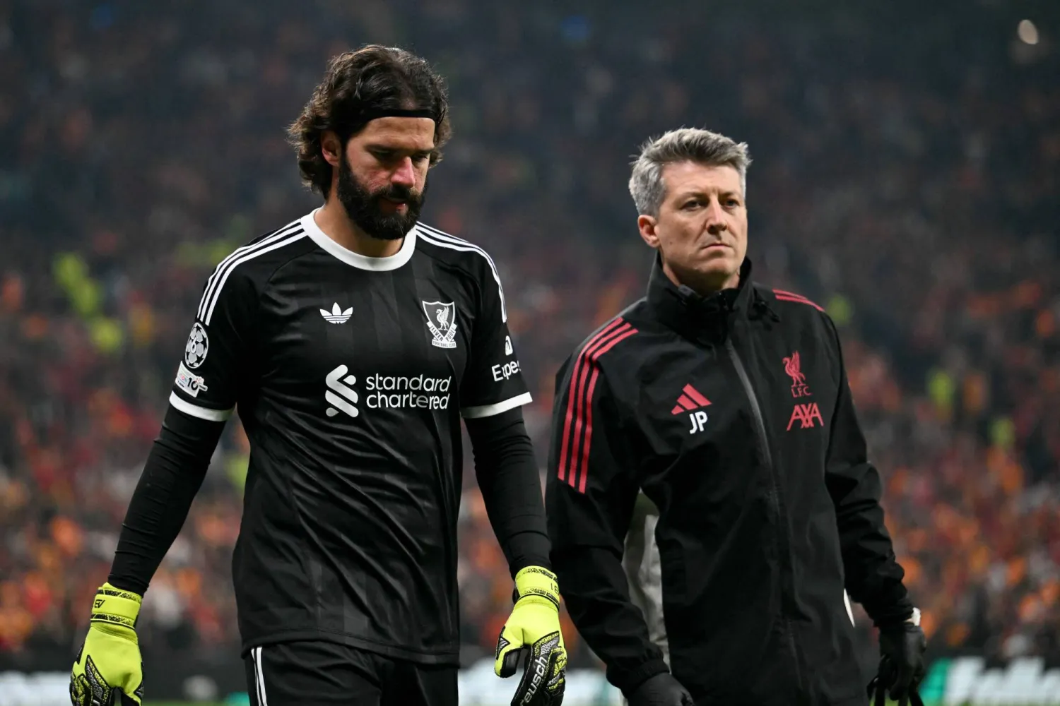 Liverpool's Brazilian goalkeeper #01 Alisson (L) walks off the pitch injured as he is substituted during the UEFA Champions League first round day 2 football match between Galatasaray (TUR) and Liverpool (ENG) at the Ali Sami Yen Spor Kompleksi in Istanbul on September 17, 2025. (AFP)