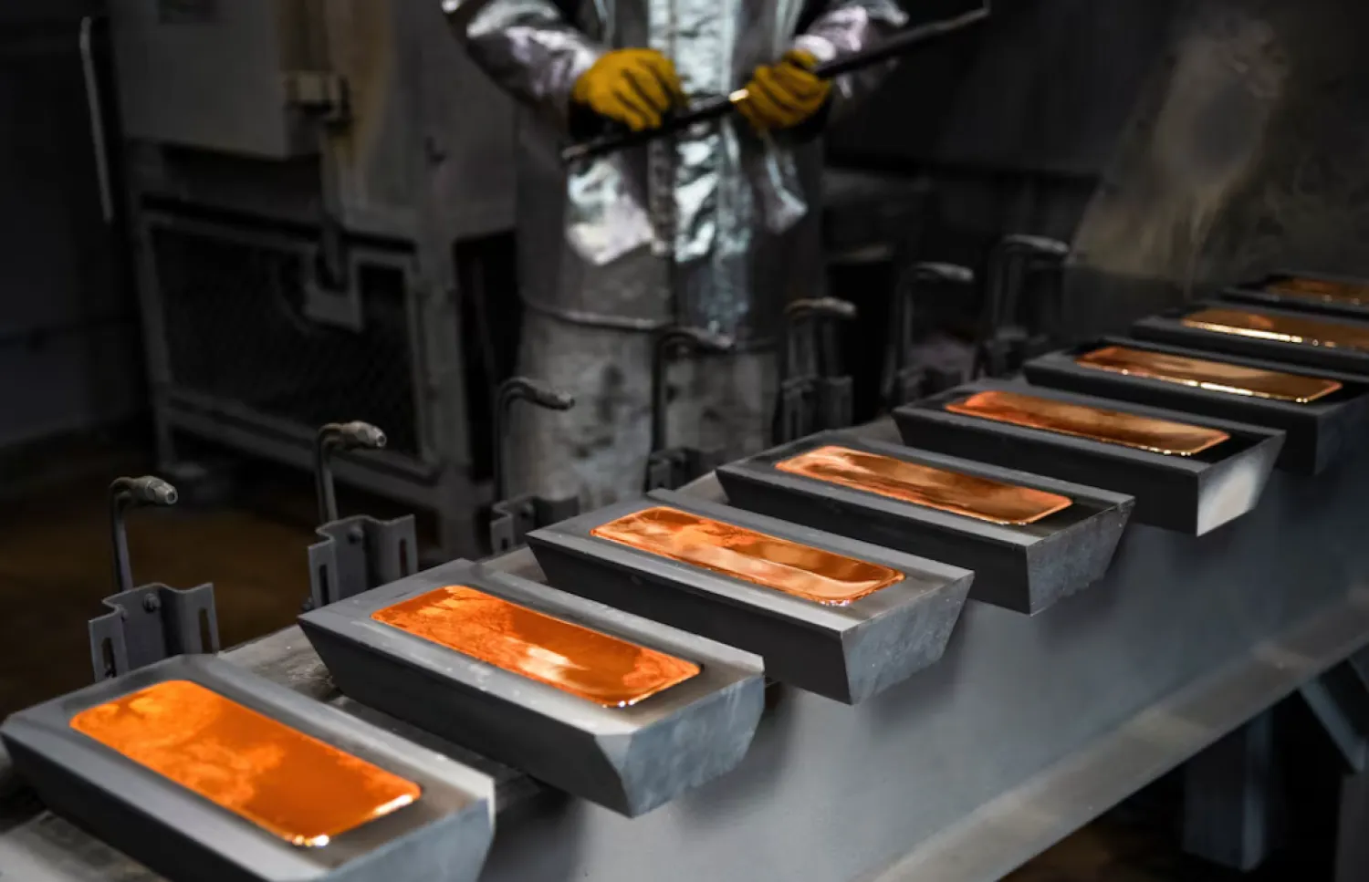 An employee casts ingots of 99.99 percent pure gold in a workroom during production at Krastsvetmet precious metals plant in the Siberian city of Krasnoyarsk, Russia, May 23, 2024. REUTERS/Alexander Manzyuk 