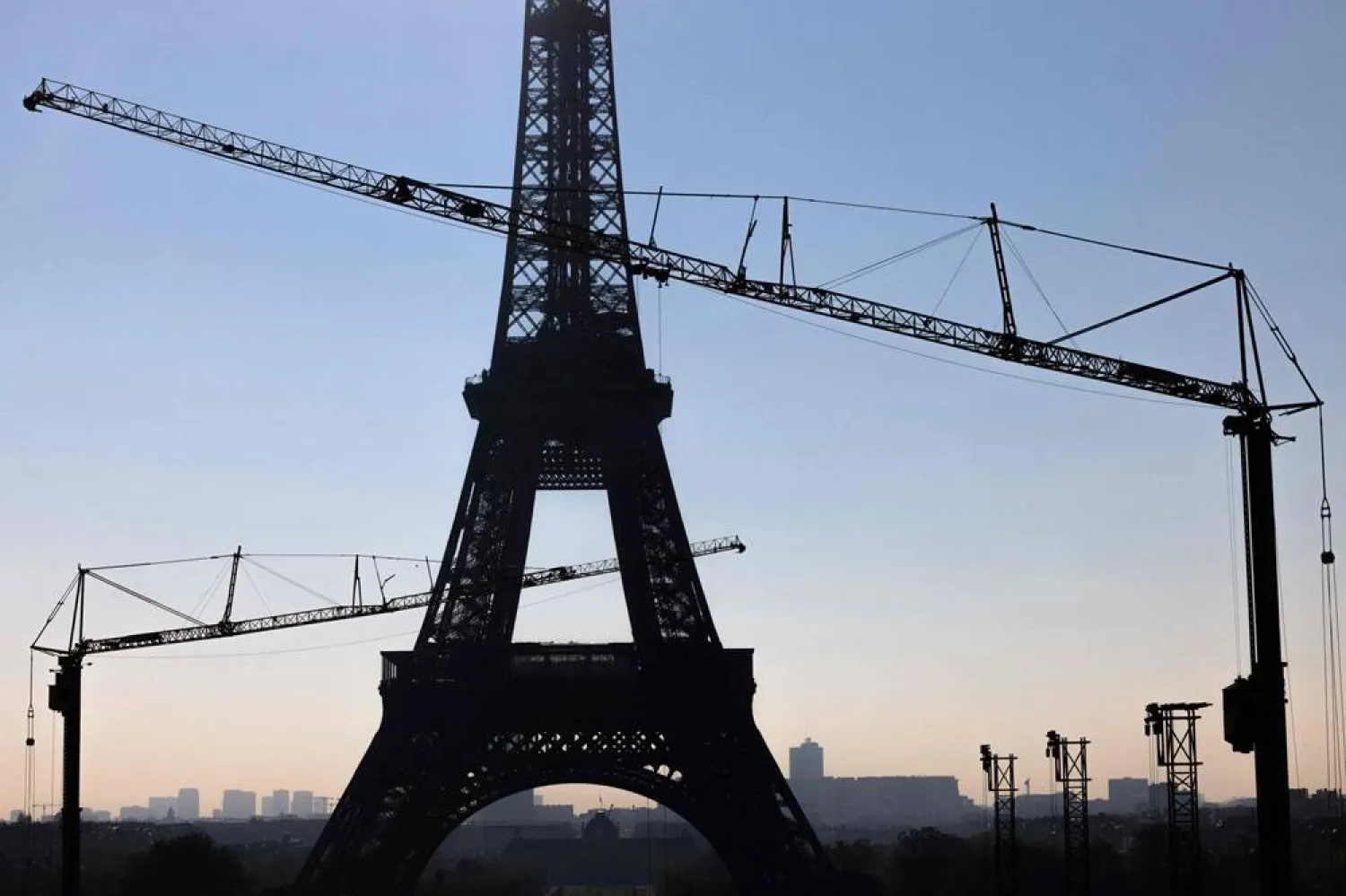 This photograph shows cranes near the Eiffel Tower in Paris on October 1, 2025. (AFP)