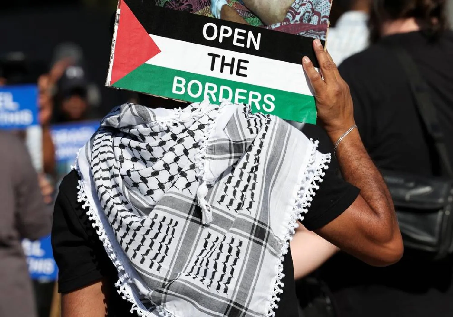  An activist holds a placard outside Israel's embassy as they protesting the detention of members of a Gaza-bound aid flotilla, in Pretoria, South Africa, October 3, 2025. (Reuters)