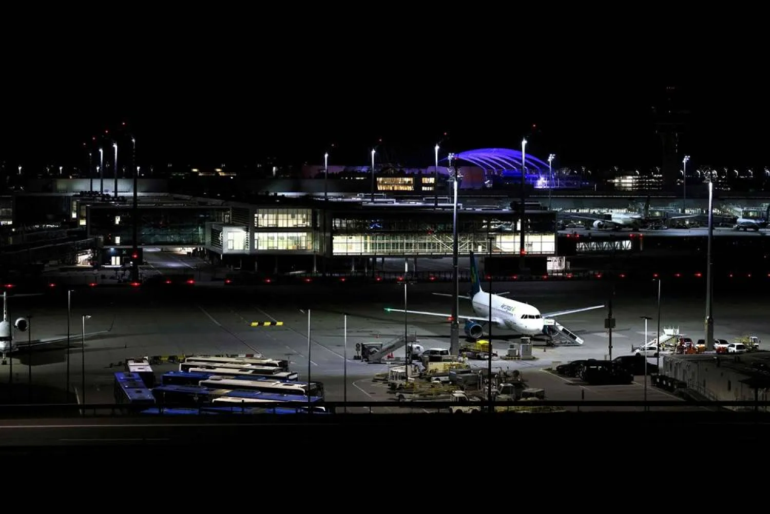 Night view shows an Air Lingus plane grounded at Munich International Airport in Munich, southern Germany, on early October 4, 2025. (AFP)