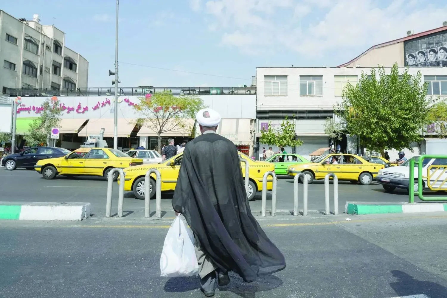 An Iranian cleric crosses Enqelab (Revolution) Street in central Tehran, September 27, 2025. (AP) 