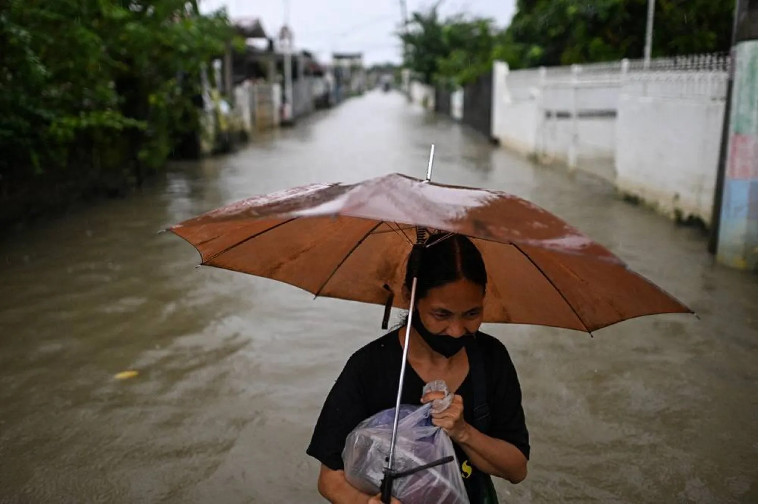 Representation photo: A woman wades through a flooded street following rain, intensified by Severe Tropical Storm Matmo, in Santa Lucia, Calumpit, Bulacan province, Philippines, October 3, 2025. (Reuters) 