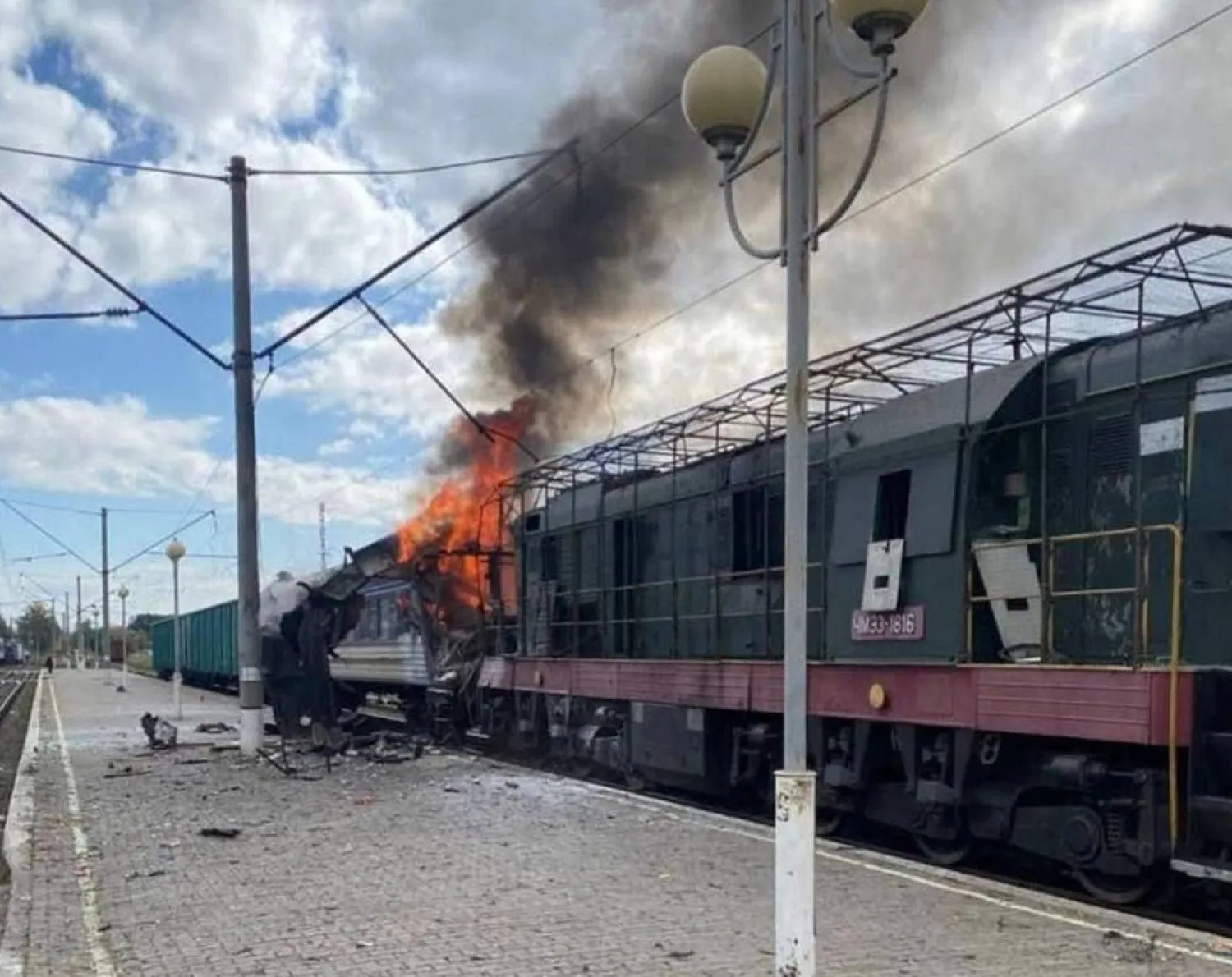  In this photo provided by the Ukrainian Railway press office, a passenger train is engulfed in flames following Russia's drone attack on a railway station in Shostka, Sumy region, Ukraine, Saturday, Oct. 4, 2025. (Ukrainian Railway via AP) 