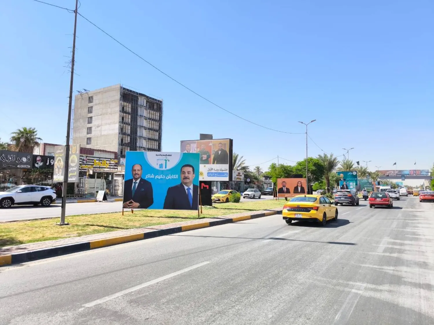 صور مرشحين في «شارع فلسطين» ببغداد (الشرق الأوسط)