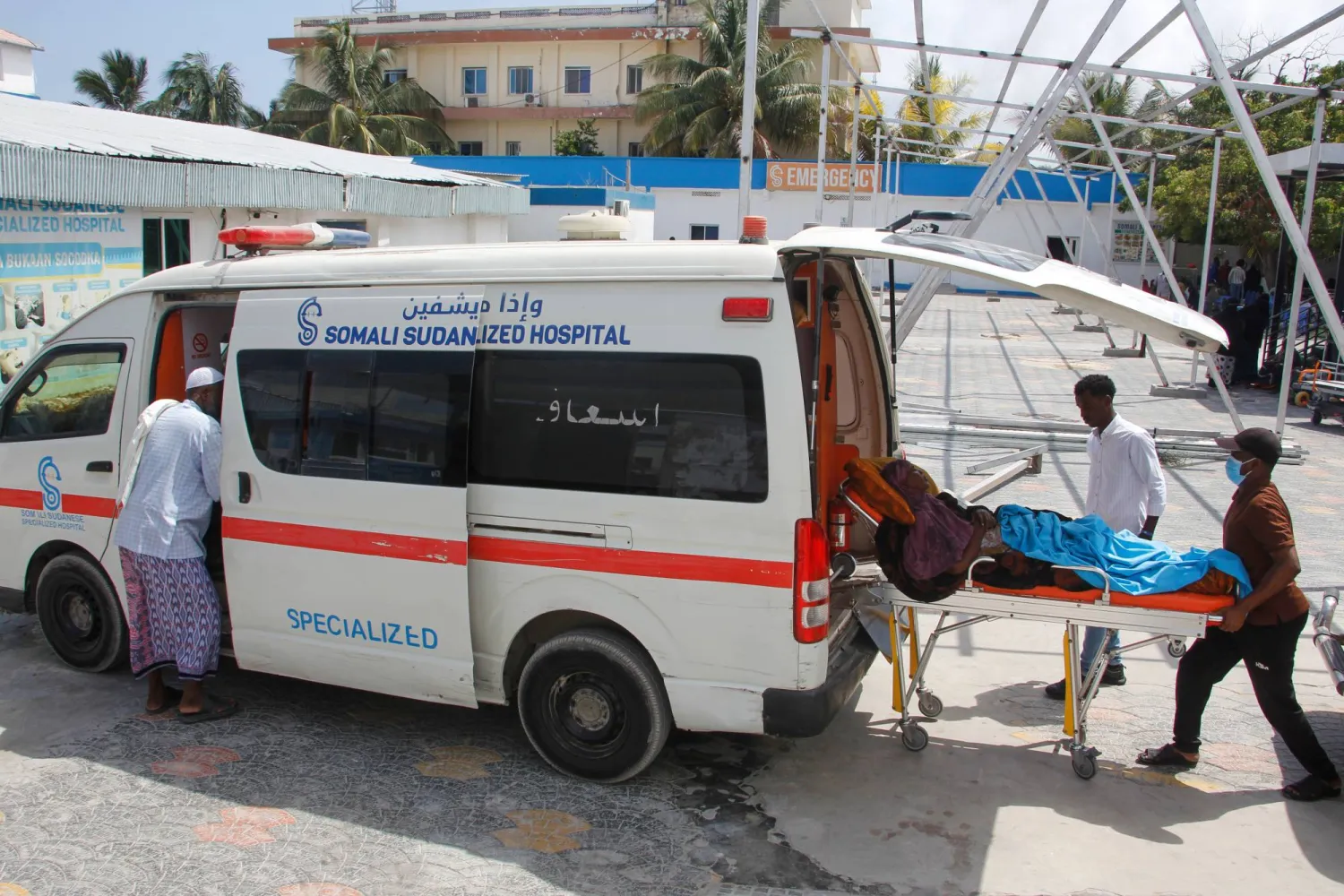 A patient is helped into an ambulance after an hours-long militant attack in Mogadishu, Somalia, on Sunday, Oct. 5, 2025. (AP Photo/Farah Abdi Warsameh)