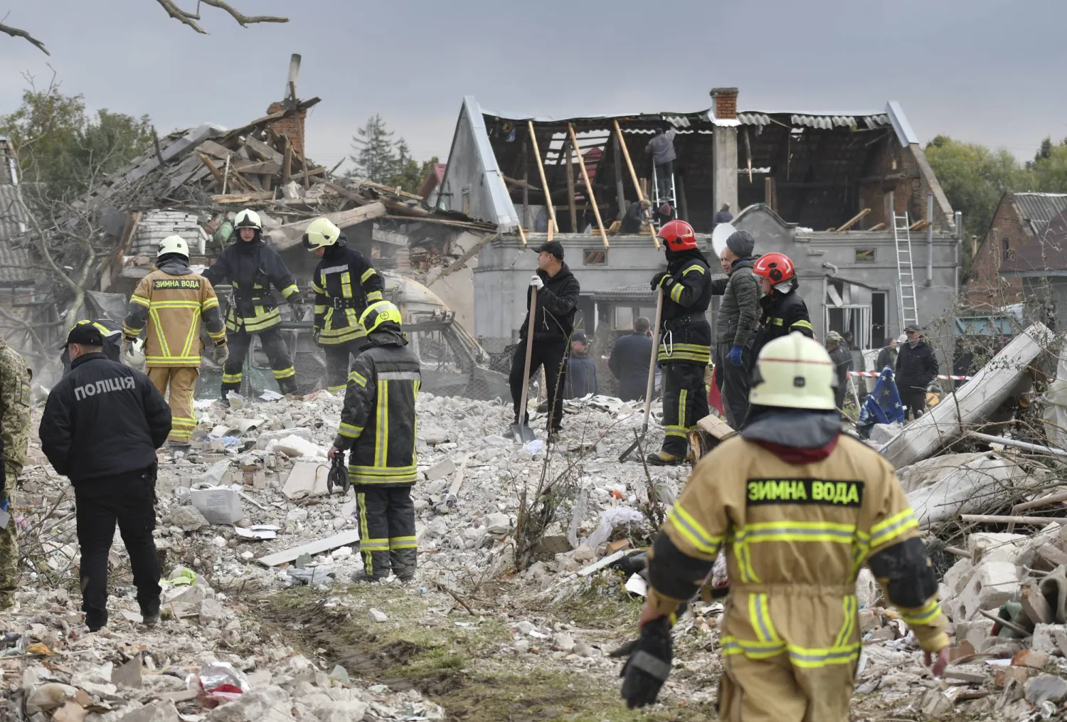 عاملو إنقاذ يعملون في موقع استهدفه قصف روسي على مدينة لفيف يوم 5 أكتوبر (إ.ب.أ)