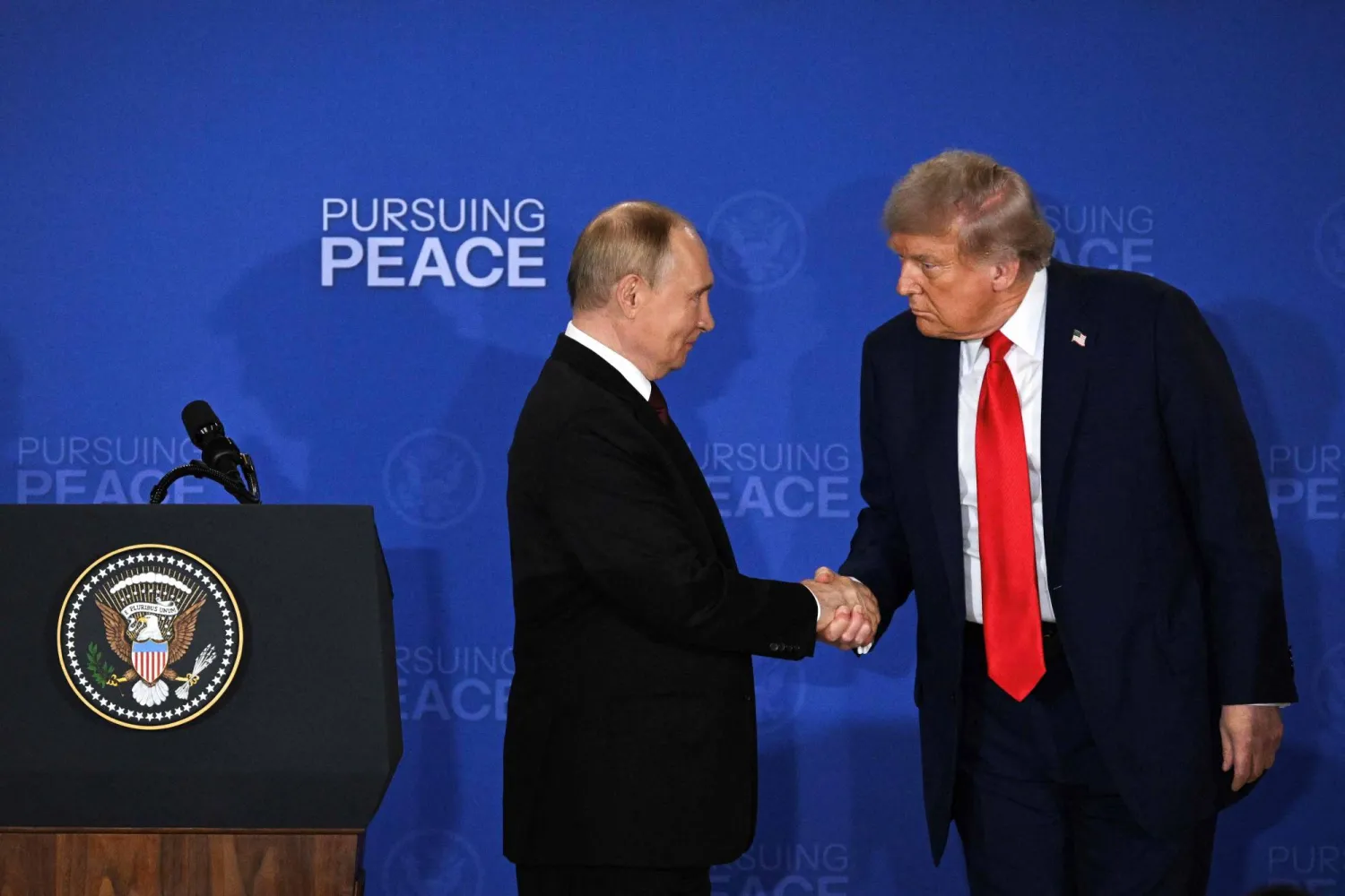 US President Donald Trump (right) and Russian President Vladimir Putin shake hands at the end of a press conference at the Joint Base Elmendorf-Richardson in Anchorage on Aug 15. (AFP) 