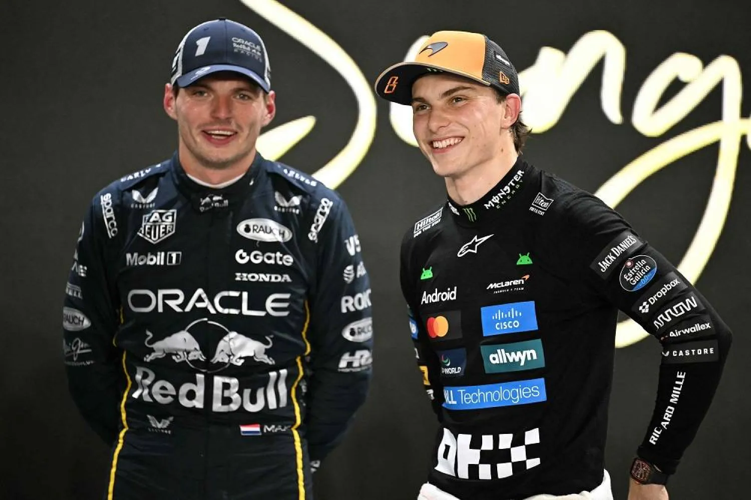 Second-placed Red Bull Racing's Dutch driver Max Verstappen (L) and third-placed McLaren's Australian driver Oscar Piastri (R) talk after the qualifying session for the Formula One Singapore Grand Prix night race at the Marina Bay Street Circuit in Singapore on October 4, 2025. (AFP)