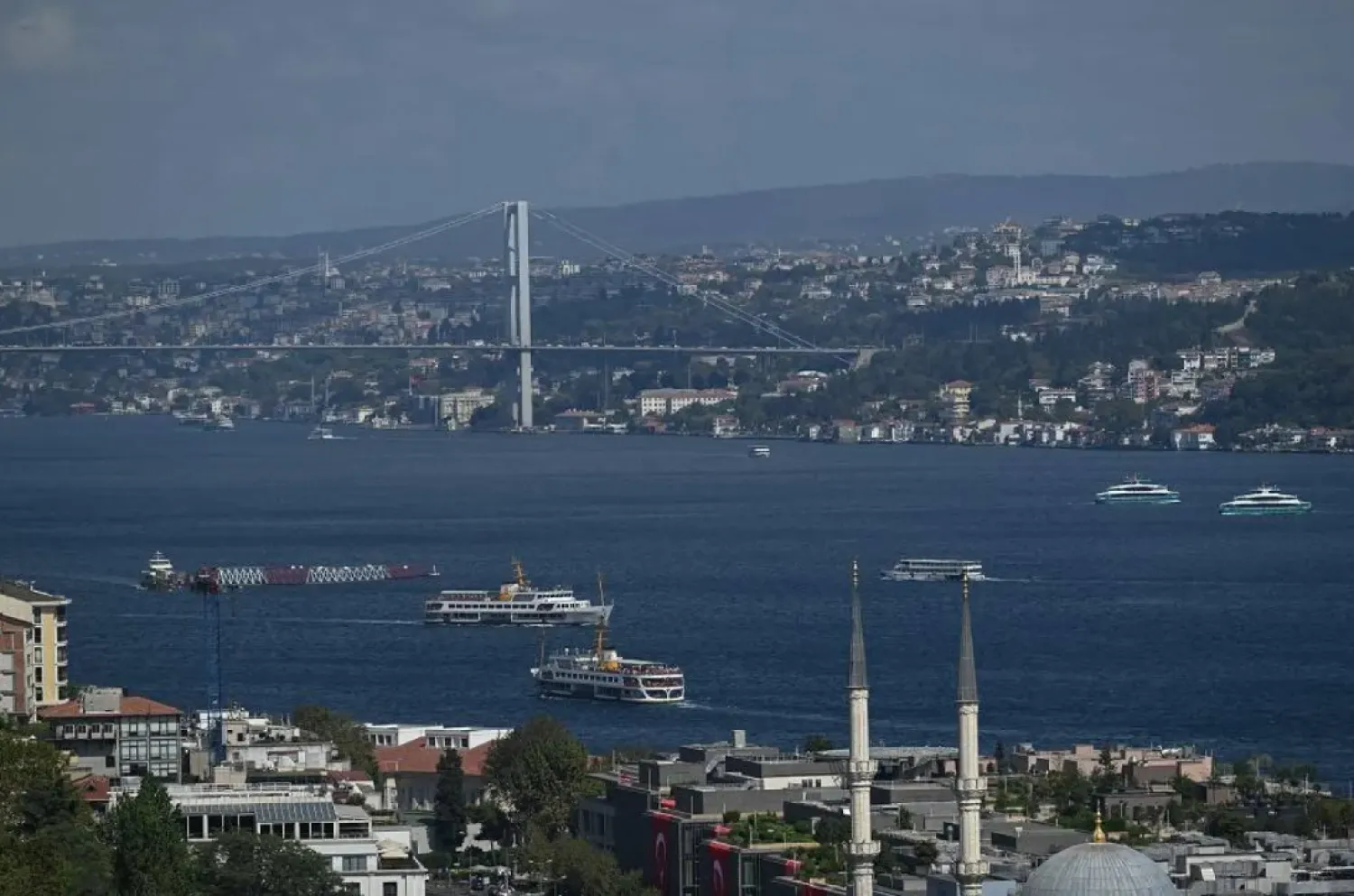 Ferries sail the Bosphorus in Istanbul, on August 29,2025, next to the 15 July Martyrs Bridge, known as Bosphorus bridge. (AFP)
