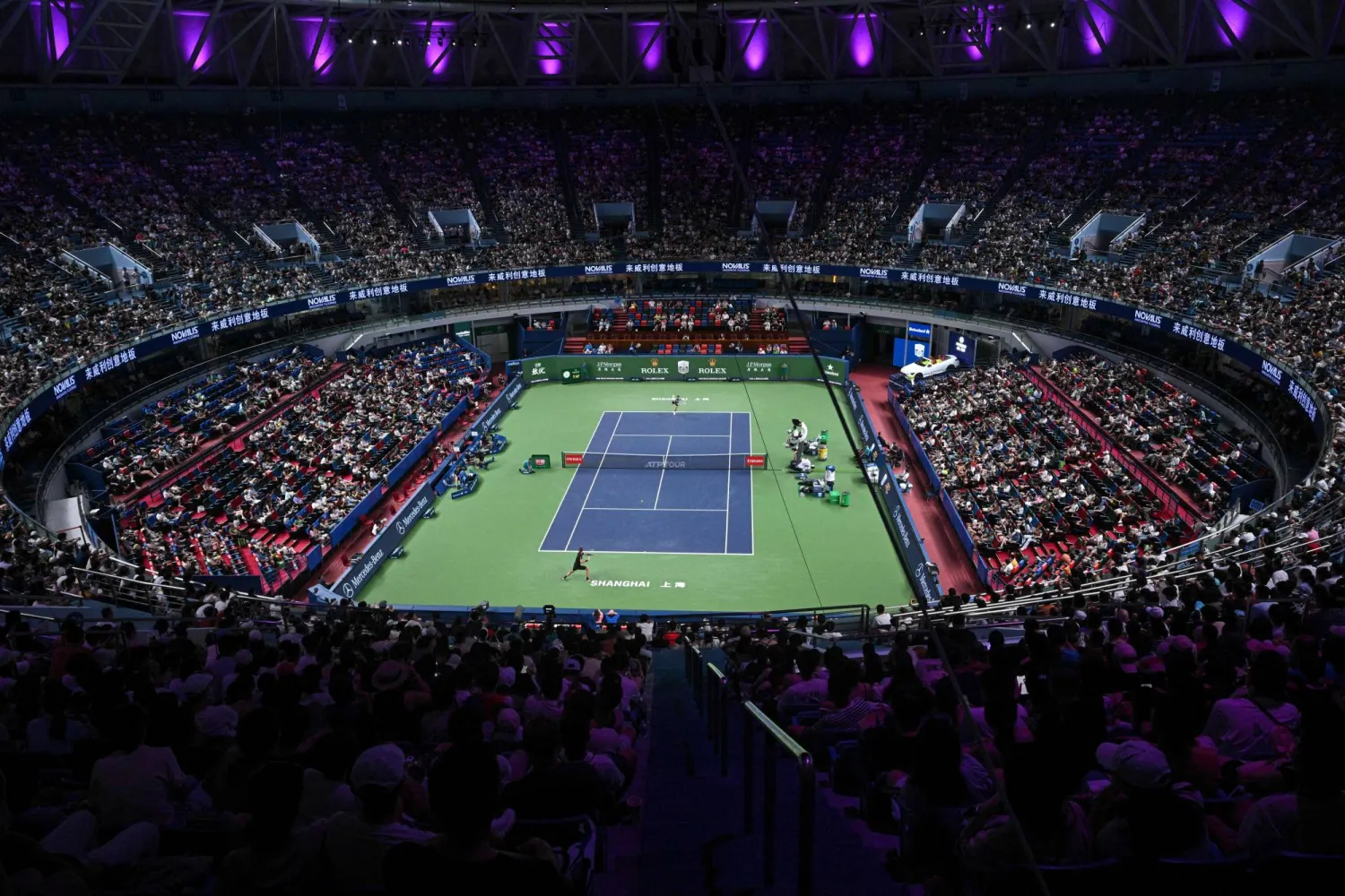 Germany's Alexander Zverev (bottom) hits a return to France's Arthur Rinderknech during their men's singles match at the Shanghai Masters tennis tournament in Shanghai on October 6, 2025. (Photo by Hector RETAMAL / AFP)