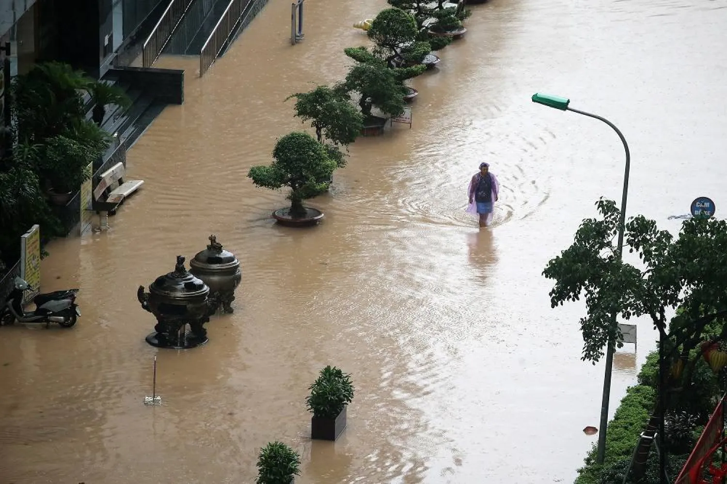 A man wades through a flooded street in Hanoi, Vietnam, 07 October 2025. Torrential rains triggered by Typhoon Matmo caused flooding in Hanoi’s streets on 07 October. (EPA)