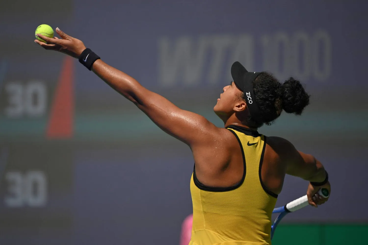 Japan's Naomi Osaka serves against Canada's Leylah Fernandez during their women's singles match at the Wuhan Open tennis tournament in Wuhan, Central China's Hubei province on October 7, 2025. (Photo by Adek BERRY / AFP)