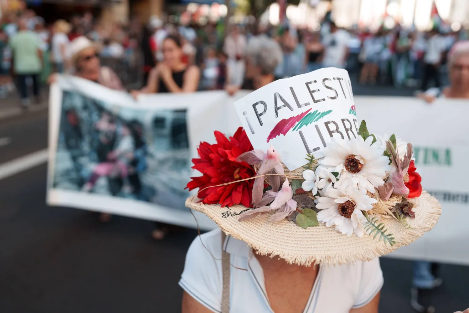 A demonstrator wearing a hat reading “Free Palestine” takes part in a rally in support of the Palestinian people in the Canary Islands, southwestern Spain (EPA). 