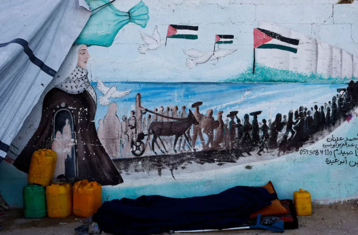 A displaced Palestinian man, who fled his home due to the Israeli military offensive, sleeps in front of his tent, in Nuseirat, central Gaza Strip, October 7, 2025. REUTERS/Mahmoud Issa 