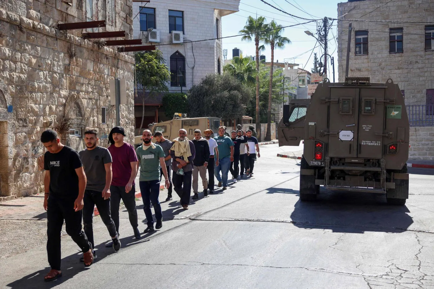 Israeli soldiers detain a Palestinian man during a raid in Ramallah city in the occupied West Bank on October 7, 2025. (AFP) 