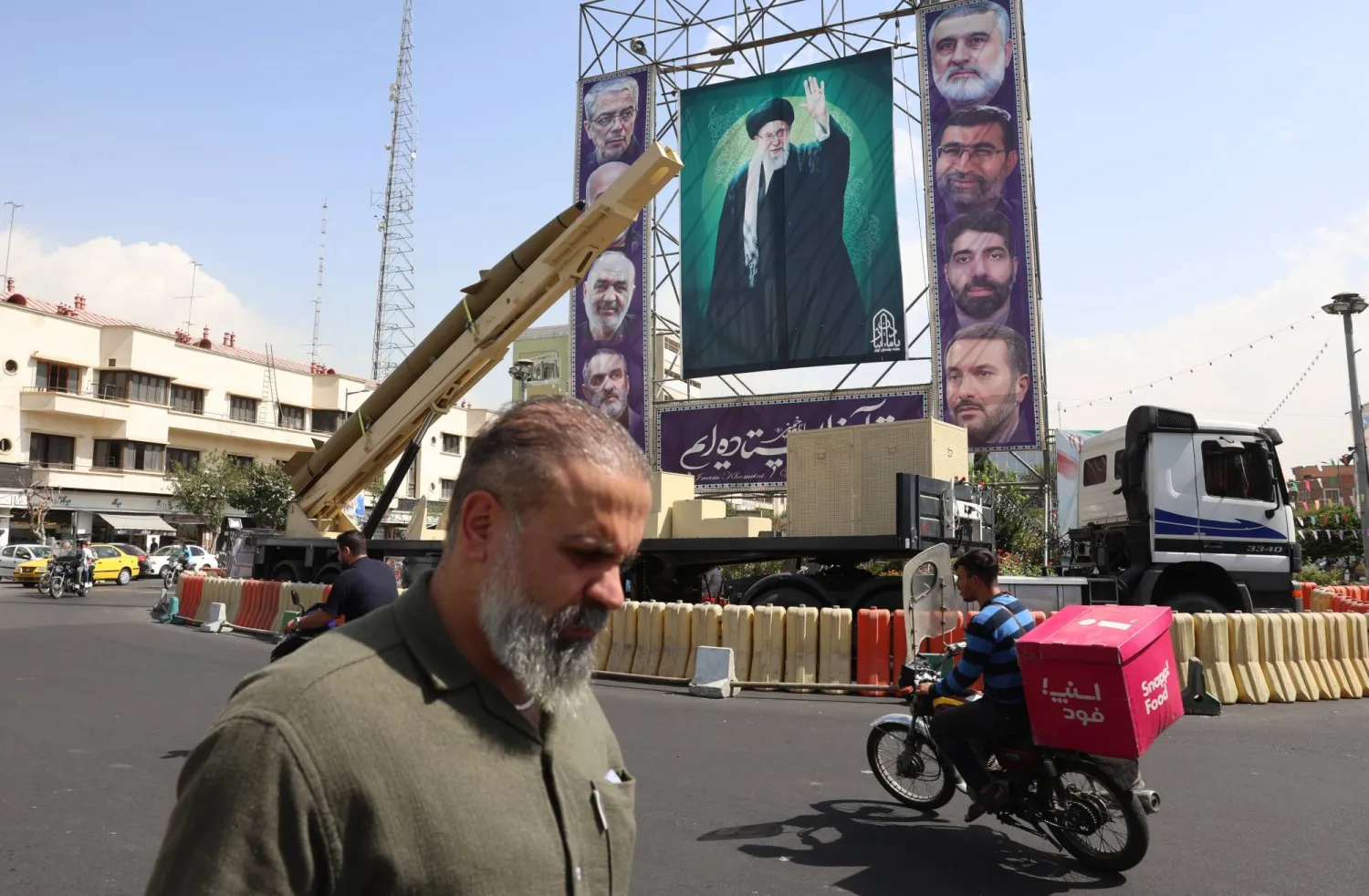 An Iranian Kheibar-Shekan medium-range ballistic missile (MRBM) placed next to a large banner depicting Iranian Supreme Leader Ali Khamenei (C) in Baharestan Square in Tehran, Iran, 27 September 2025. EPA/ABEDIN TAHERKENAREH