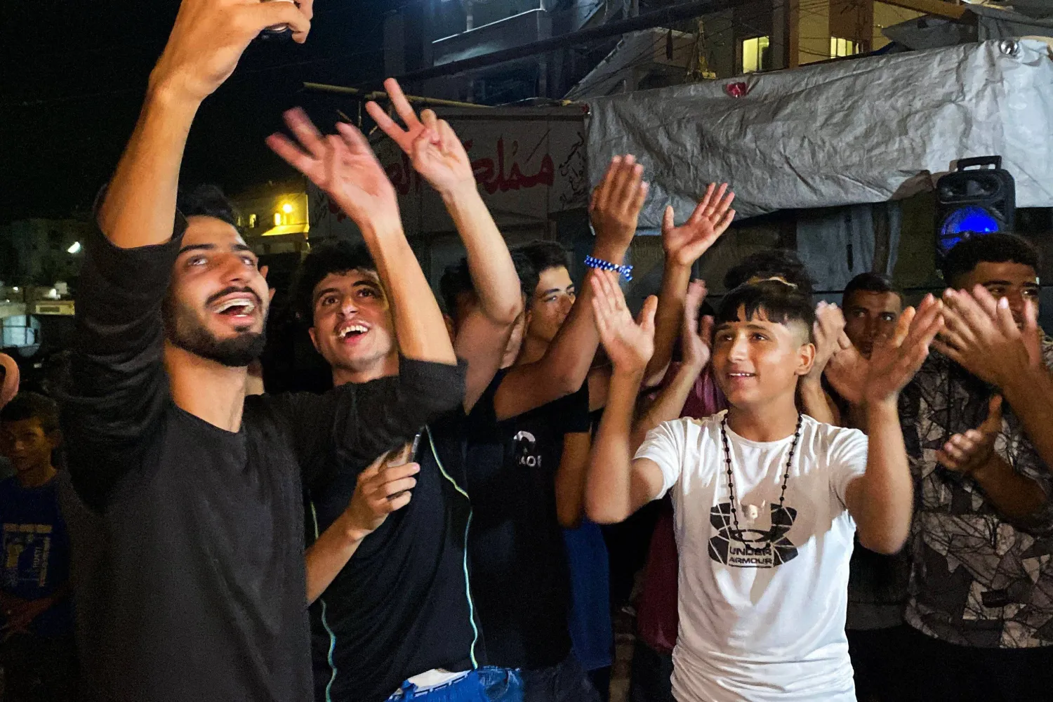 Palestinians celebrate in Khan Yunis on October 9, 2025, following news of a new Gaza ceasefire deal. (Photo by AFP)