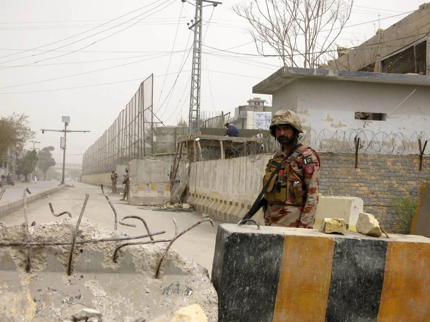 Paramilitary soldiers of Frontier Corps (FC) stand guard as laborers repair the boundary wall that was damaged in a suicide bombing in Quetta, the provincial capital of restive Balochistan province, Pakistan, 06 October 2025. EPA/FAYYAZ AHMED