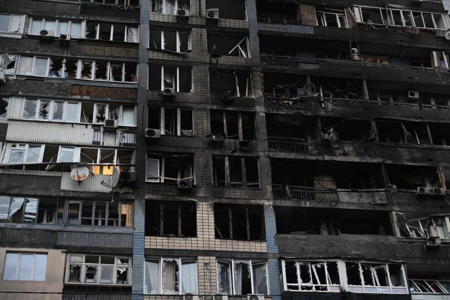 A general view shows a residential building damaged during massive Russian drone and missile strikes in the Ukrainian capital Kyiv on October 10, 2025, amid the Russian invasion of Ukraine. (Photo by Genya SAVILOV / AFP)
