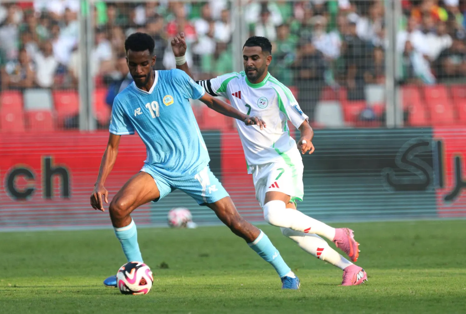 Algeria player Riyad Mahrez (R) in action against Somalia player Faysal Abubakar Osman  (L) during the 2026 FIFA World Cup Qualifiers soccer match between Somalia and Algeria in Oran, Algeria, 09 October 2025.  EPA/STR