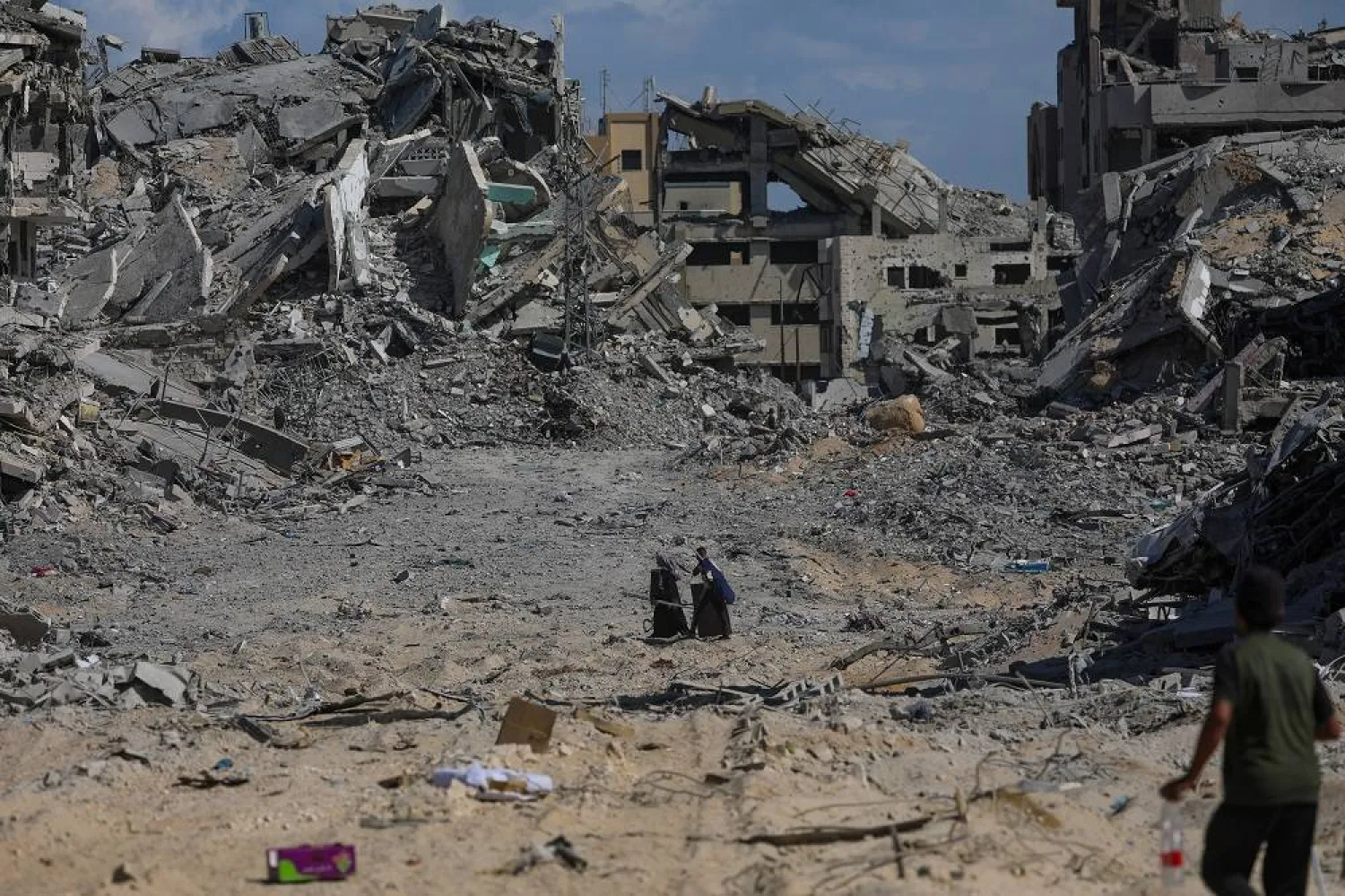 Palestinians walk along a street amid the rubble of destroyed buildings during a ceasefire between Israel and Hamas under the first phase of the Gaza peace plan, in Gaza City, Gaza Strip, 10 October 2025. (EPA)
