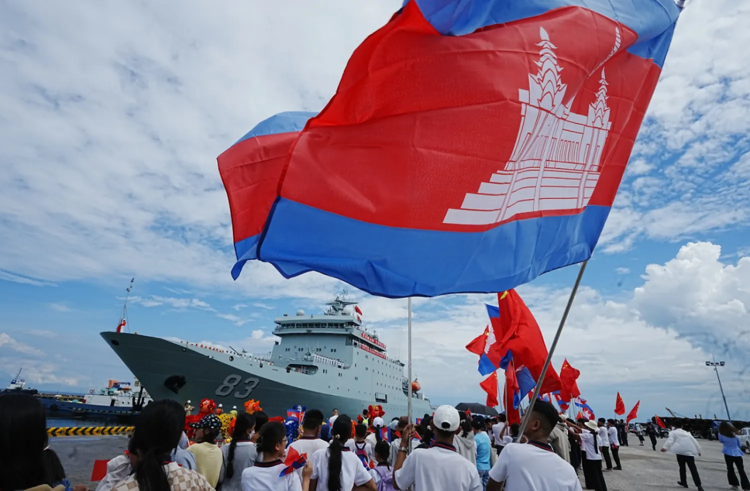 Chinese businessmen and local students gather as Chinese warship Qijiguang arrives at a commercial port in Sihanoukville, southern Cambodia, Friday, Oct. 10, 2025. (AP Photo/Heng Sinith)