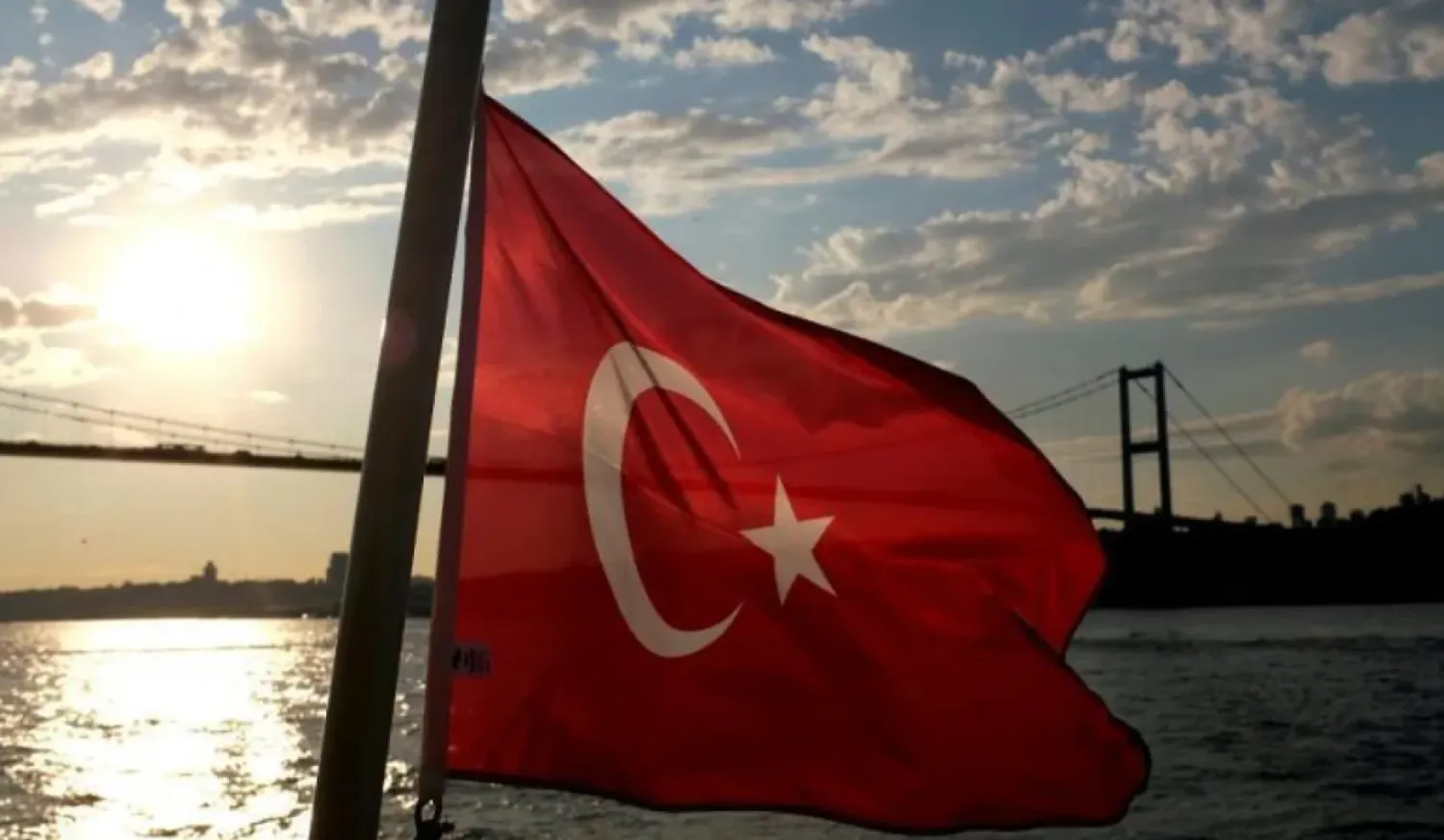 A Turkish flag with the Bosphorus Bridge in the background, flies on a passenger ferry in Istanbul, September 30, 2020. (Reuters)
