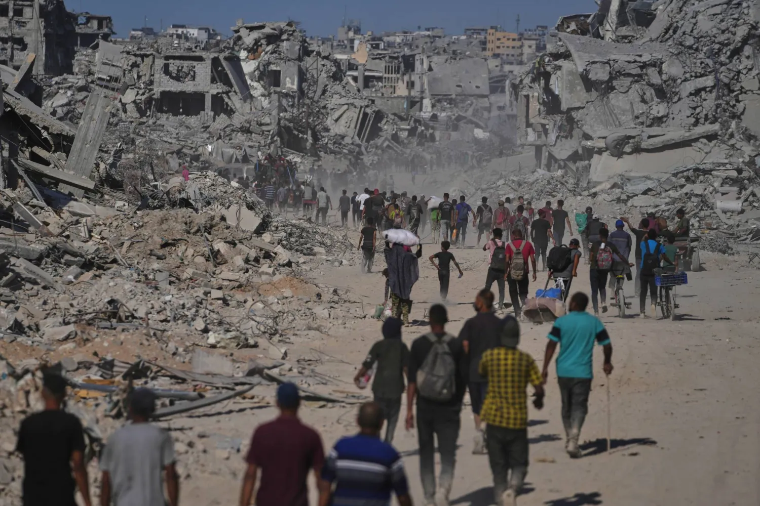 Displaced Palestinians walk past destroyed buildings as they return to their homes in the Zeitoun neighborhood of Gaza City, Friday, Oct. 10, 2025, after Israel and Hamas agreed to a pause in their war and the release of remaining hostages. (AP) 