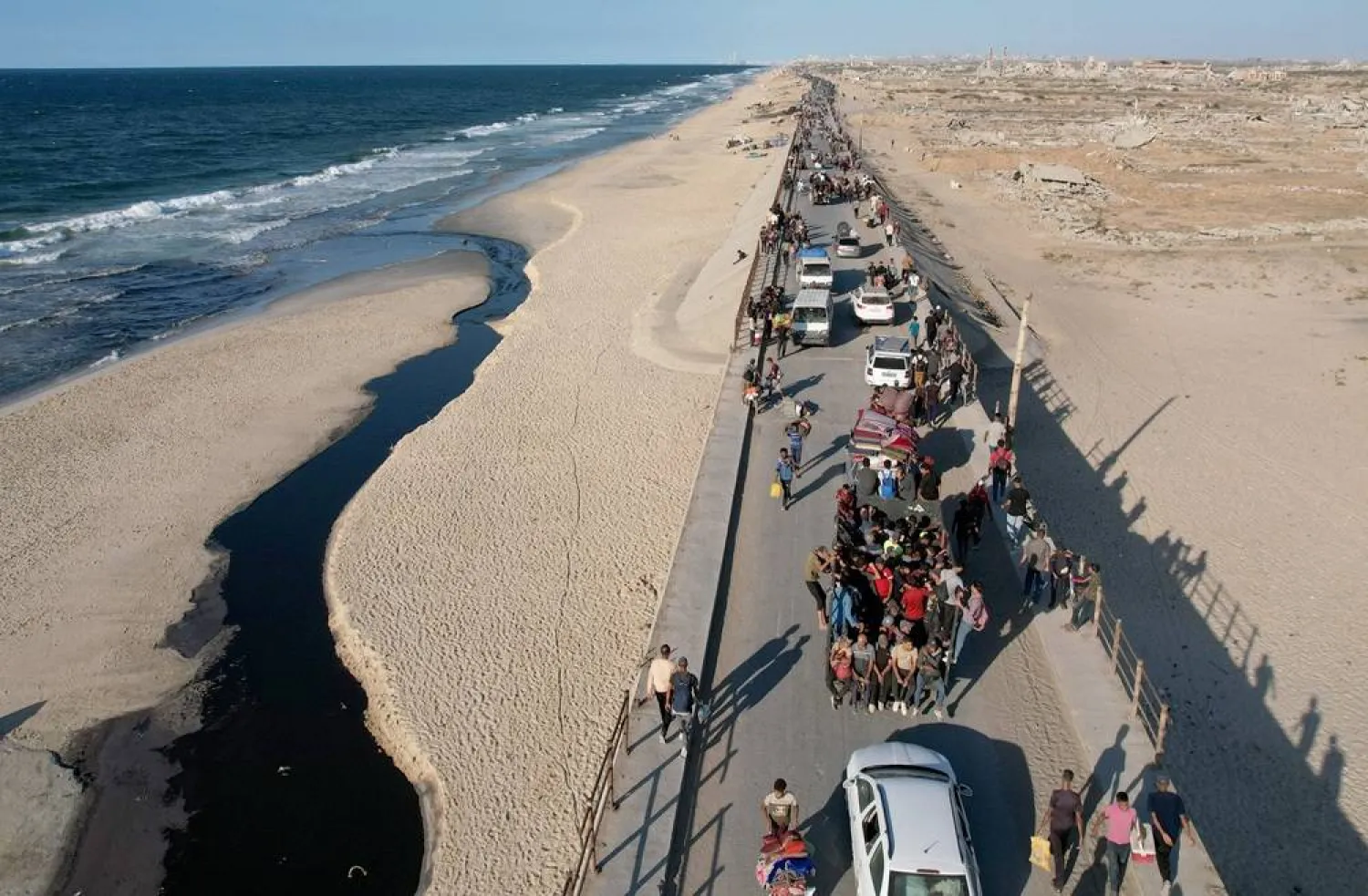  A drone view shows Palestinians, who were displaced to the southern part of Gaza at Israel's order during the war, making their way along a road to return to the north after a ceasefire between Israel and Hamas in Gaza went into effect, in the central Gaza Strip, October 10, 2025. (Reuters)