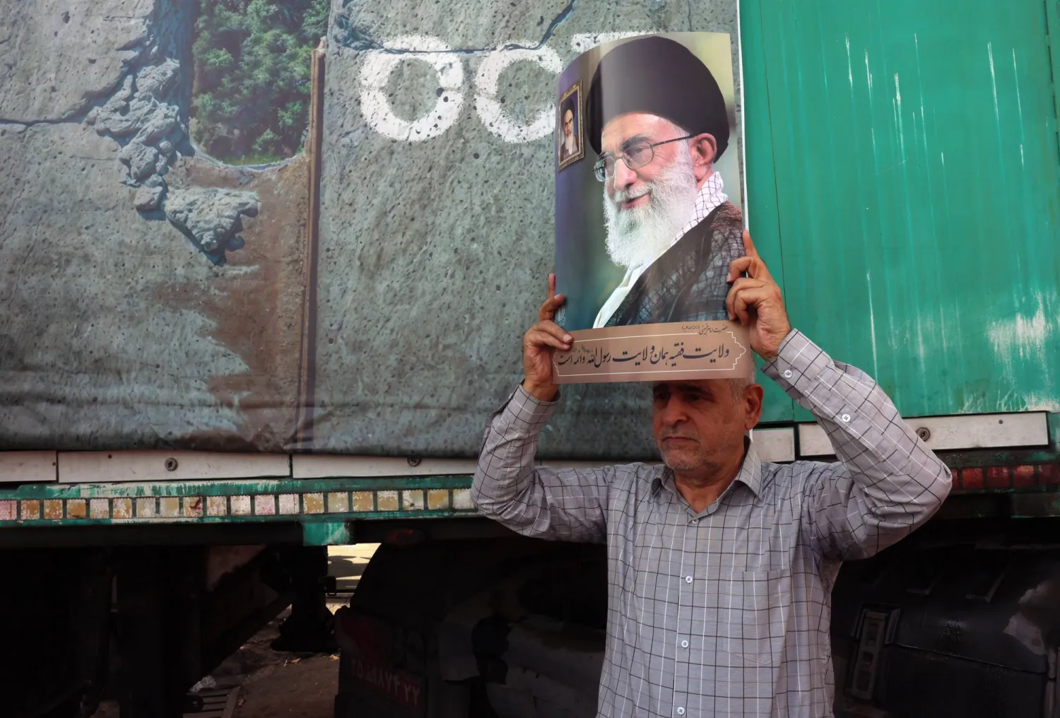 An Iranian man holds a picture of Iranian Supreme Leader Ali Khamenei while taking part in a pro-Palestine rally in Tehran, Iran, 10 October 2025.  EPA/ABEDIN TAHERKENAREH