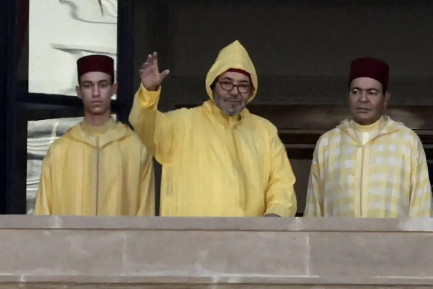 Morocco’s king arrives at parliament balcony with crown prince and brother (AFP)