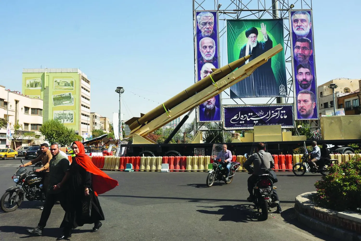 An Iranian missile system is displayed next to a banner with a picture of Iran's Supreme Leader Ali Khamenei during the Iranian Defense Week, in a street in Tehran, Iran, September 25, 2025. Majid Asgaripour/WANA (West Asia News Agency) via REUTERS  