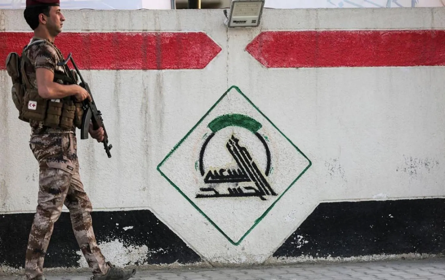 A mural depicting the logo of the Popular Mobilization Forces (PMF). (AFP)