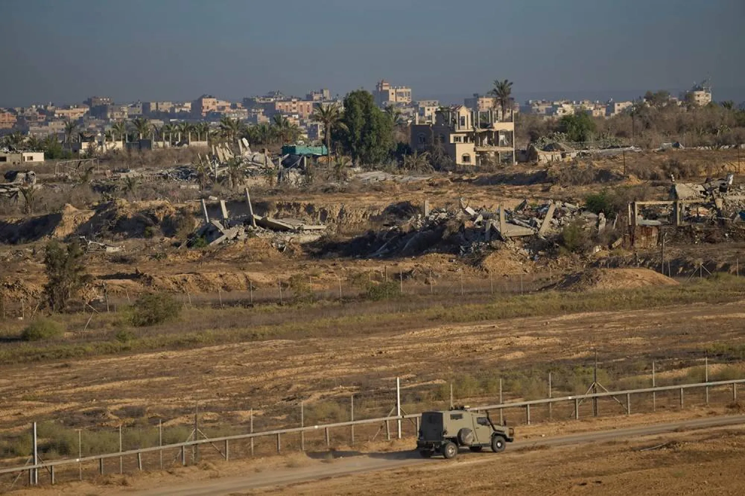 An Israeli army vehicle moves along the border of the Gaza strip, as seen from a southern Israel location on Saturday, Oct. 11, 2025, as part of the preparations surrounding the expected release of hostages under the agreement between Hamas and Israel to pause the war and free the remaining captives. (AP)